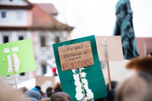 protest sign reading, "Respect our existence or expect resistance."